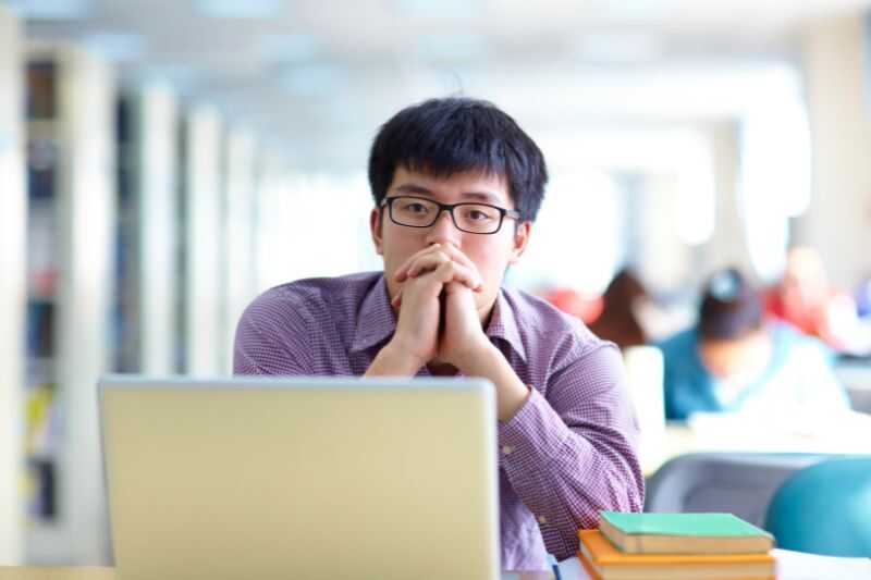 A Man Sitting At A Computer