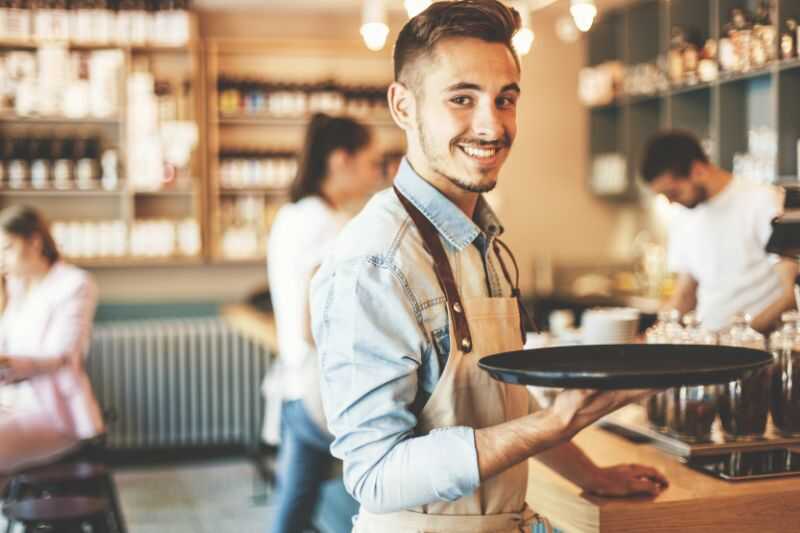 A Waiter Holding A Tray