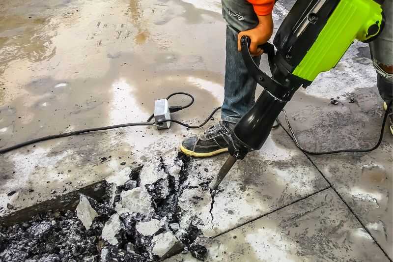 A Worker Drilling In The Street