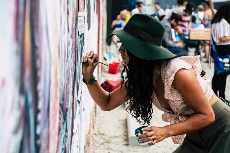 A Woman Painting A Mural