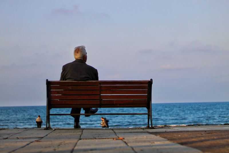 A Pensioner Sitting On A Bench