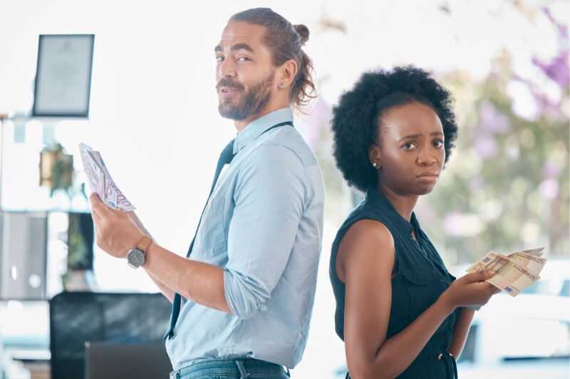 Two People Holding Banknotes