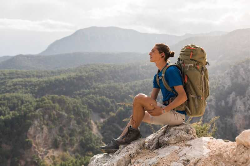 A Climber Resting On A Mountain Peak