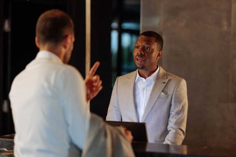 A Man Complaining At Hotel Reception