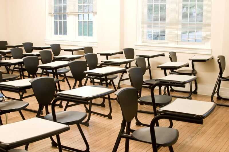 A Row Of Desks In An Empty Classroom