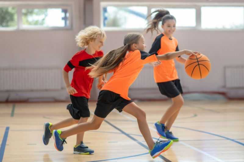 Three Children Playing Basketball