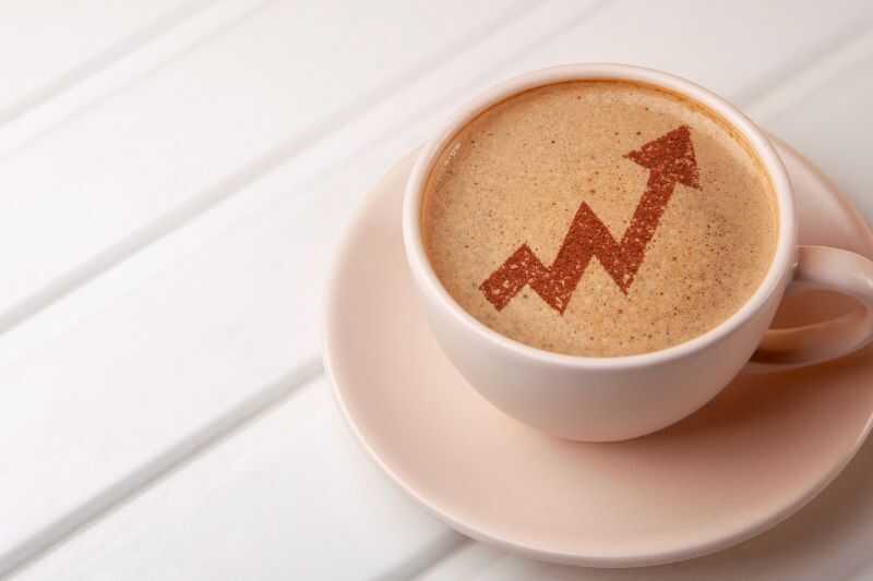 A Cup Of Coffee Decorated With An Arrow Design