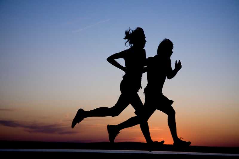 A Pair Of Runners At Dusk