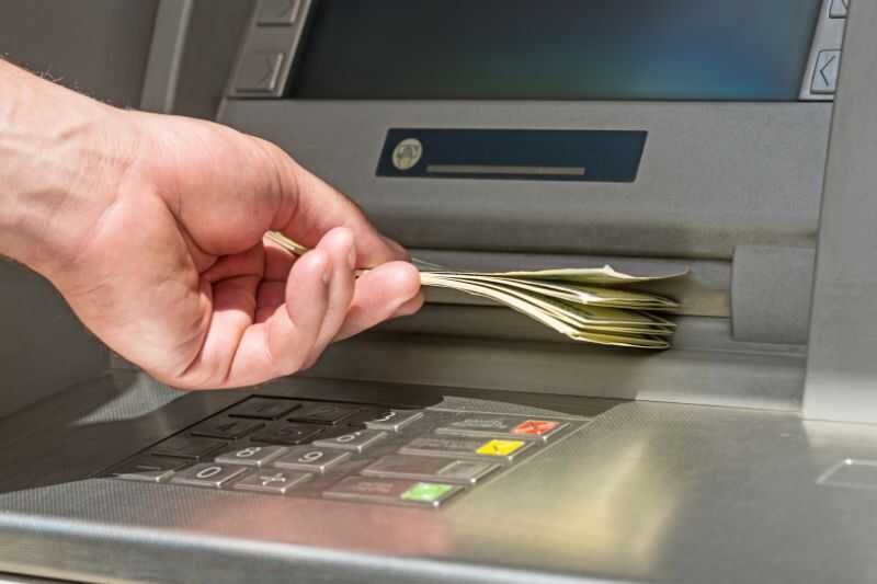 A Man Withdrawing Cash From An Atm