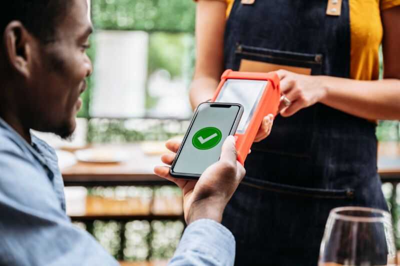 A Man Making A Contactless Payment