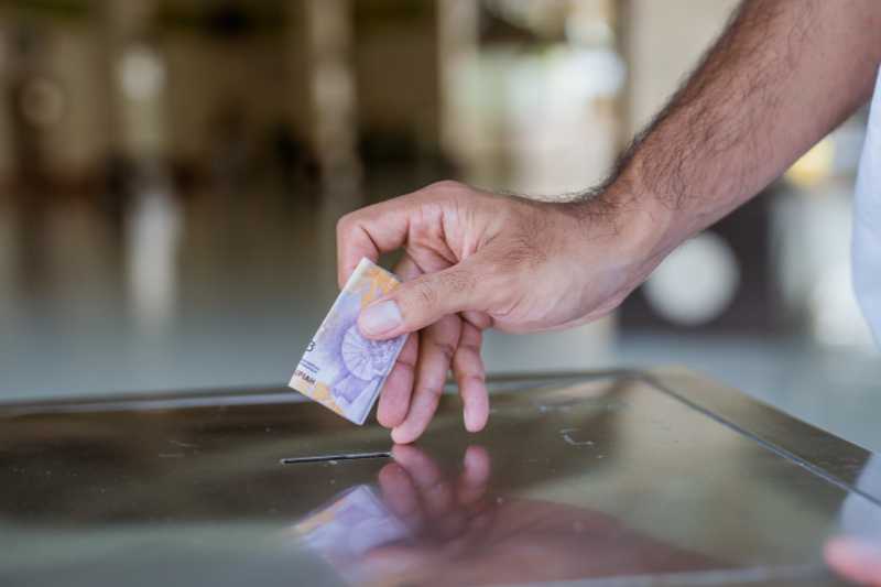 A Man Making A Donation At A Mosque