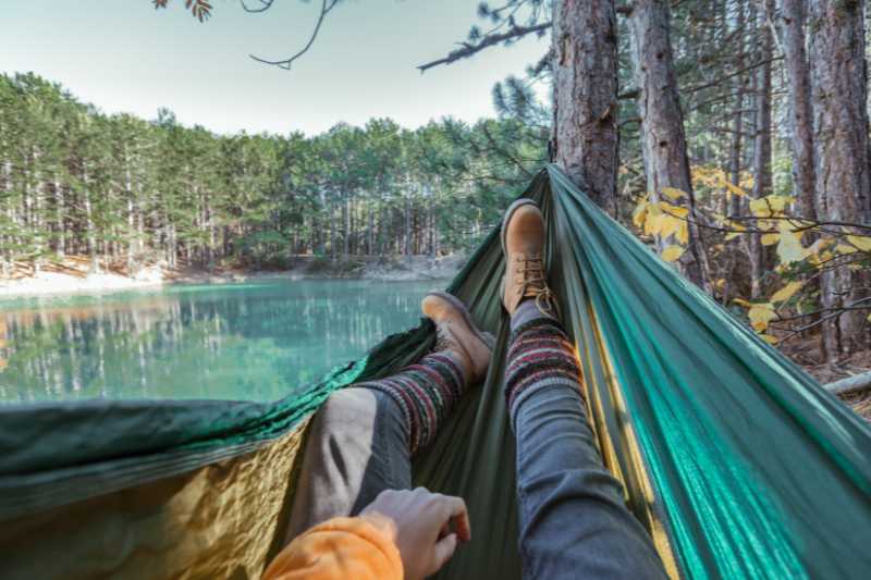 A Man Relaxing In A Hammock In Nature